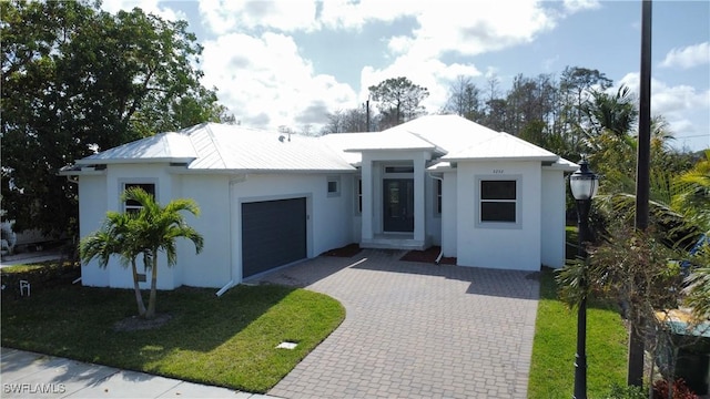 view of front facade with a garage and a front lawn