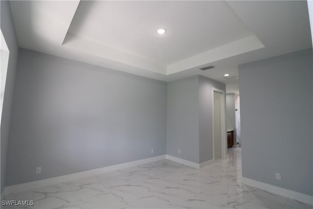 empty room featuring a tray ceiling