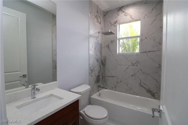 full bathroom featuring tiled shower / bath, vanity, and toilet