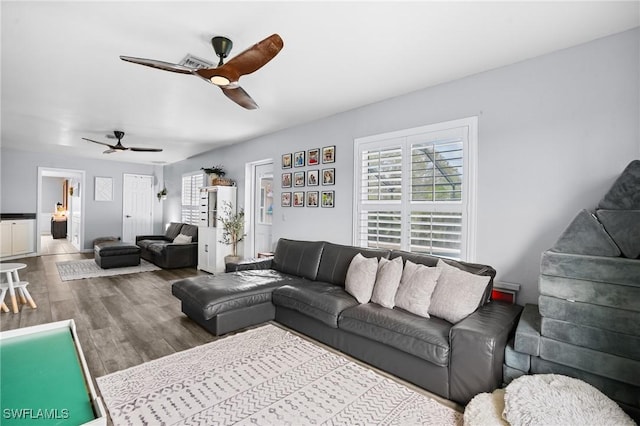 living room with a ceiling fan and wood finished floors