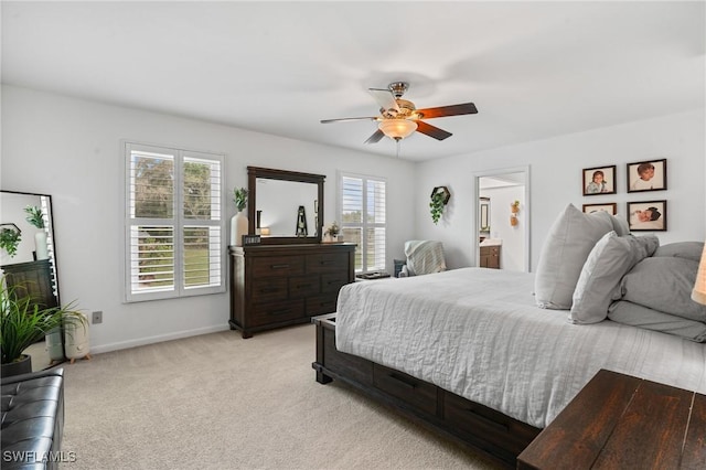 bedroom featuring baseboards, a ceiling fan, and light colored carpet