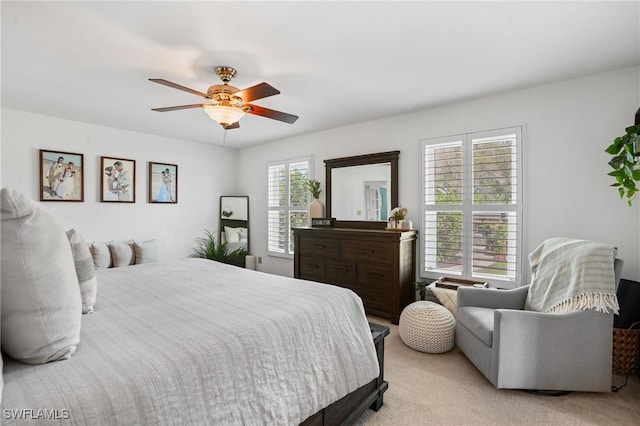 bedroom with ceiling fan and light colored carpet