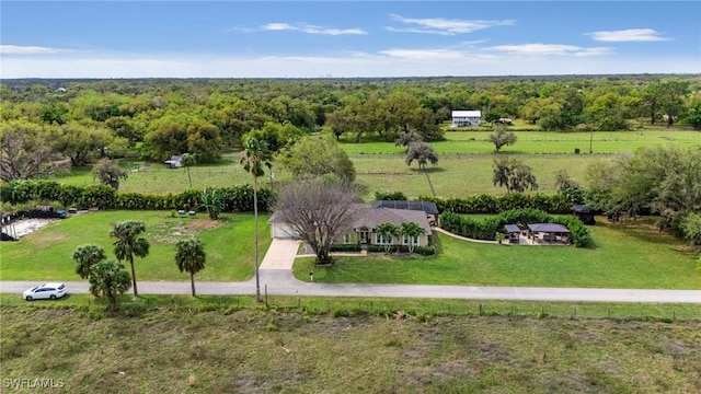 drone / aerial view featuring a wooded view and a rural view