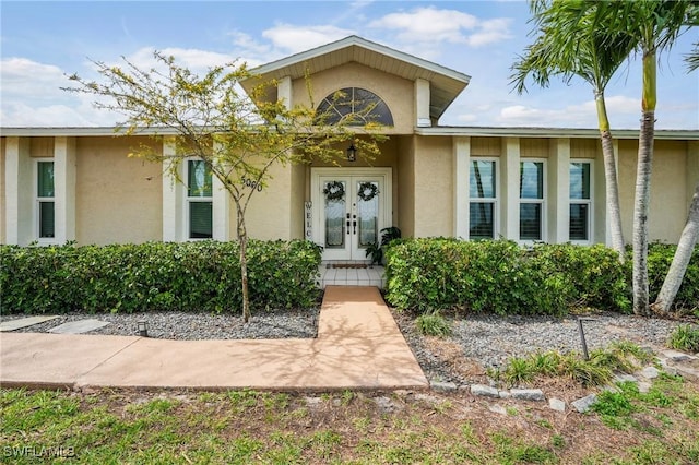 5060 Melaluca Dr, Fort Myers, FL 33905 - doorway to property with french doors and stucco siding
