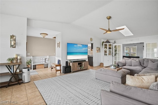 5060 Melaluca Dr, Fort Myers, FL 33905 - living room featuring a skylight, light tile patterned flooring, vaulted ceiling, and a ceiling fan