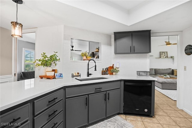 kitchen with light tile patterned floors, gray cabinetry, a sink, black dishwasher, and light countertops