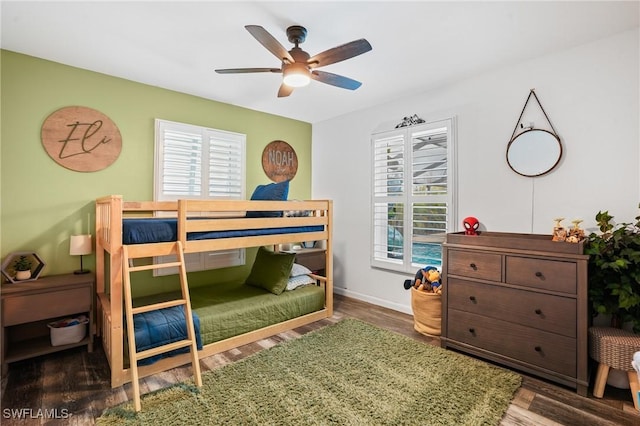 bedroom with ceiling fan, baseboards, and wood finished floors