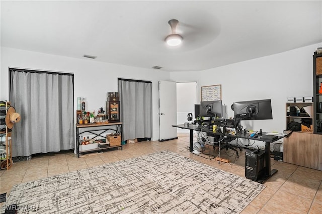 office featuring ceiling fan, visible vents, and tile patterned floors