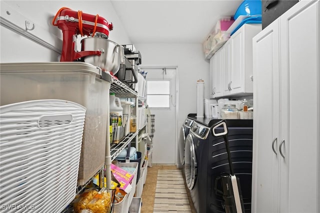 clothes washing area with cabinet space and washer and clothes dryer