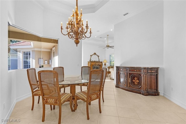 dining space featuring a tray ceiling, light tile patterned floors, visible vents, ornamental molding, and baseboards