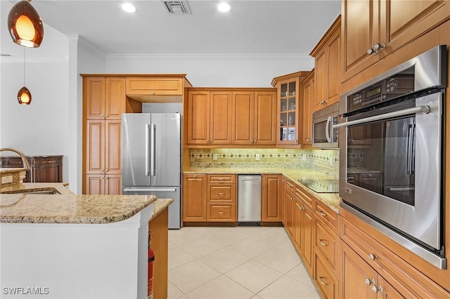 kitchen with visible vents, light stone counters, ornamental molding, stainless steel appliances, and a sink