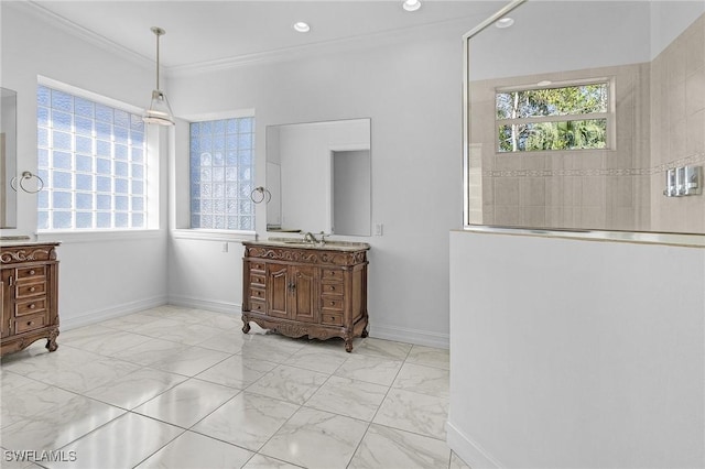 interior space featuring marble finish floor, crown molding, vanity, and baseboards