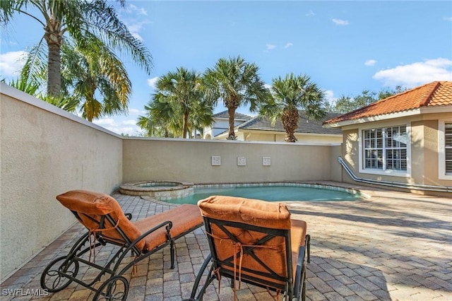 view of pool featuring an in ground hot tub, a patio area, and a fenced in pool