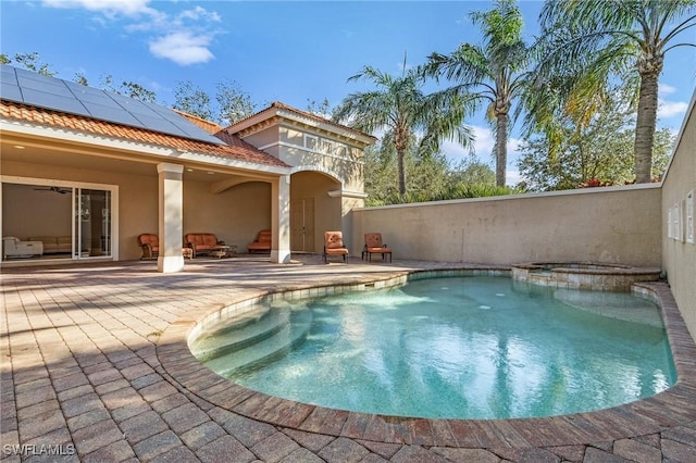 view of pool with a pool with connected hot tub and a patio