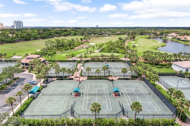 aerial view with golf course view and a water view