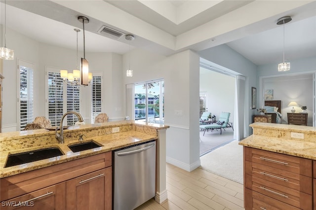 kitchen featuring light stone countertops, brown cabinetry, a sink, stainless steel dishwasher, and a chandelier