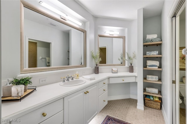 bathroom with visible vents, toilet, vanity, and tile patterned flooring