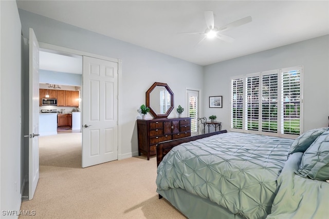 bedroom with light colored carpet, a ceiling fan, and baseboards