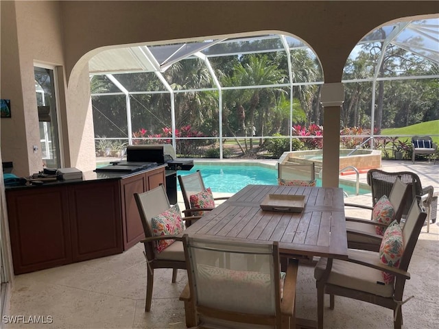 pool with an in ground hot tub, outdoor dining space, an outdoor kitchen, and a patio