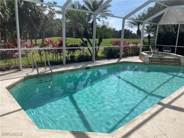 outdoor pool featuring an in ground hot tub, a patio, and a lanai