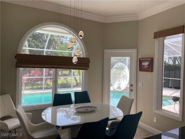 dining space featuring ornamental molding, plenty of natural light, and baseboards