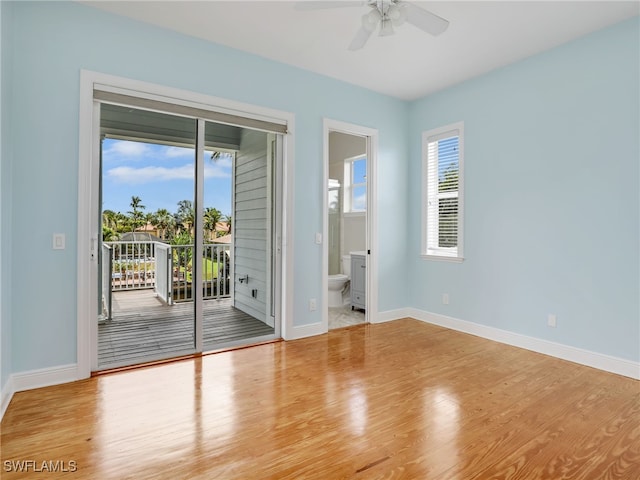 empty room featuring light wood-type flooring, a ceiling fan, and baseboards