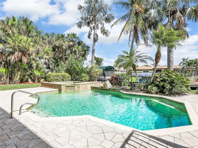 view of pool featuring a patio area and a pool with connected hot tub