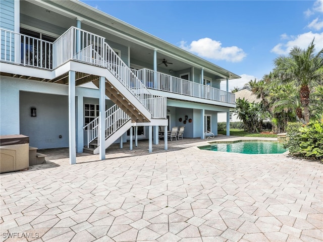 pool with ceiling fan, stairs, and a patio