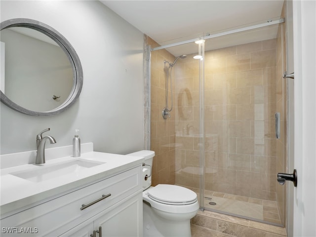 bathroom featuring toilet, a shower stall, and vanity