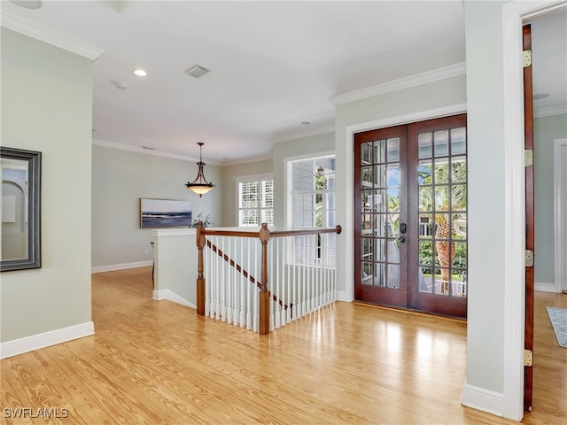 entrance foyer with light wood finished floors, french doors, and visible vents