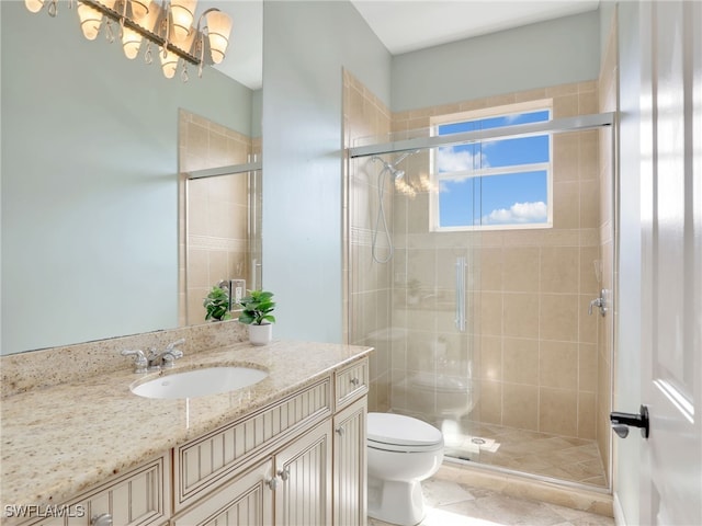 bathroom featuring a shower stall, toilet, and vanity