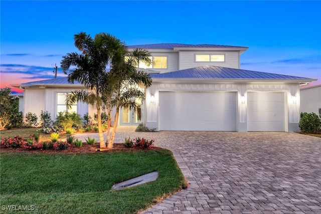 1308 Ridge St, Naples, FL 34103 - view of front facade with metal roof, decorative driveway, a garage, and a front lawn