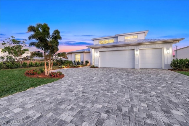 1308 Ridge St, Naples, FL 34103 - prairie-style home featuring metal roof, decorative driveway, an attached garage, a standing seam roof, and a yard