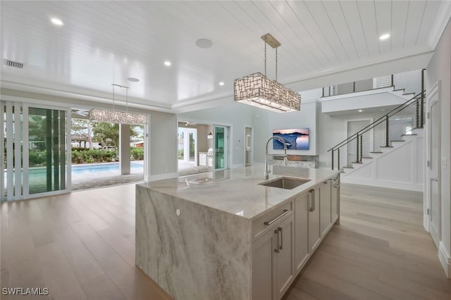 1308 Ridge St, Naples, FL 34103 - kitchen with light wood finished floors, a sink, light stone counters, and open floor plan