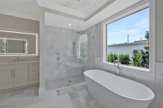 1308 Ridge St, Naples, FL 34103 - full bath featuring a freestanding tub, vanity, a shower stall, marble finish floor, and tile walls