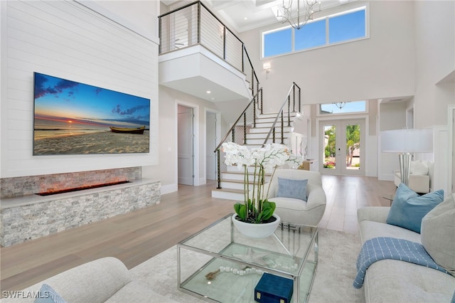 1308 Ridge St, Naples, FL 34103 - living room featuring a high ceiling, french doors, stairway, wood finished floors, and a chandelier
