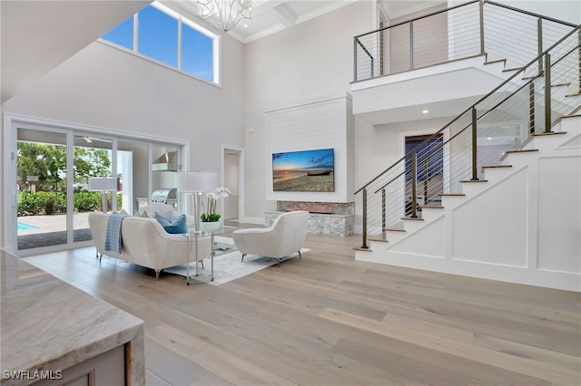 1308 Ridge St, Naples, FL 34103 - living area featuring stairway, a high ceiling, wood finished floors, a chandelier, and crown molding