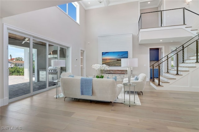 1308 Ridge St, Naples, FL 34103 - living area featuring wood finished floors, a high ceiling, stairs, ornamental molding, and a ceiling fan