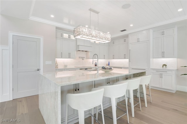 1308 Ridge St, Naples, FL 34103 - kitchen featuring light wood-style flooring, backsplash, ornamental molding, white cabinets, and recessed lighting