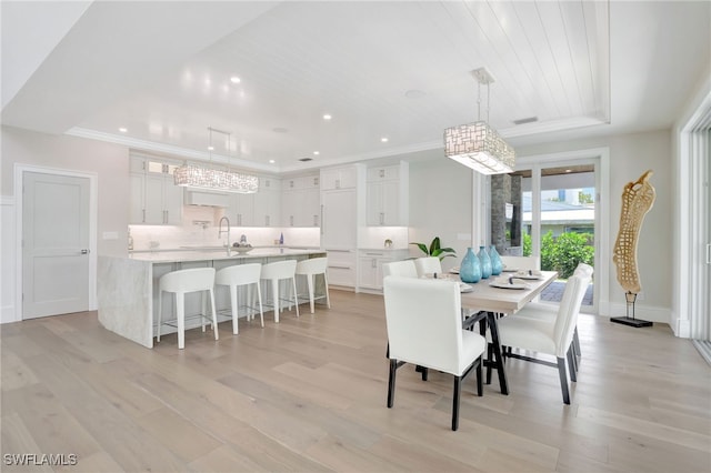 1308 Ridge St, Naples, FL 34103 - dining space featuring light wood-type flooring, recessed lighting, a tray ceiling, and crown molding