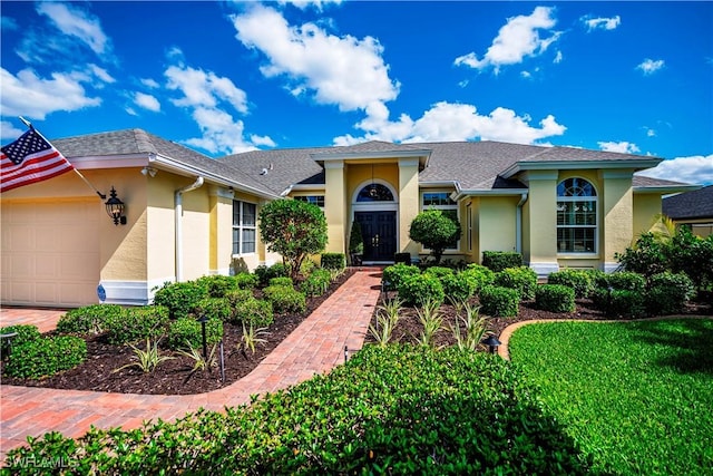 view of front of home with an attached garage and stucco siding