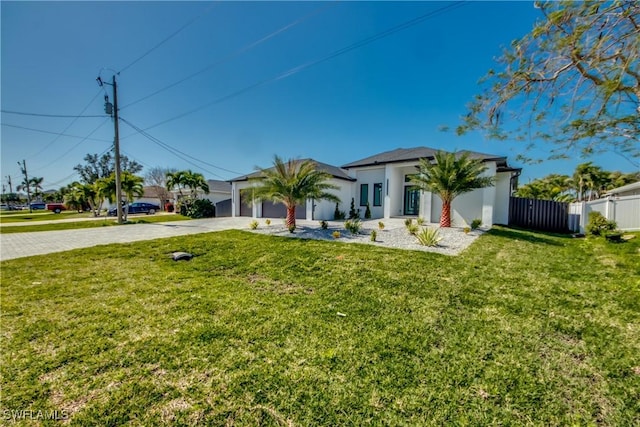 view of front of home featuring a garage and a front yard