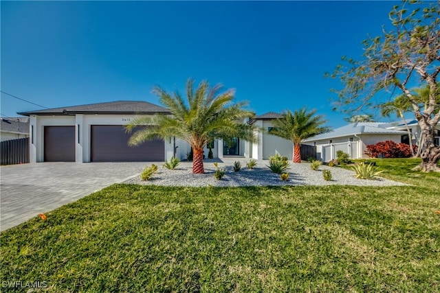 view of front of property with a garage and a front yard