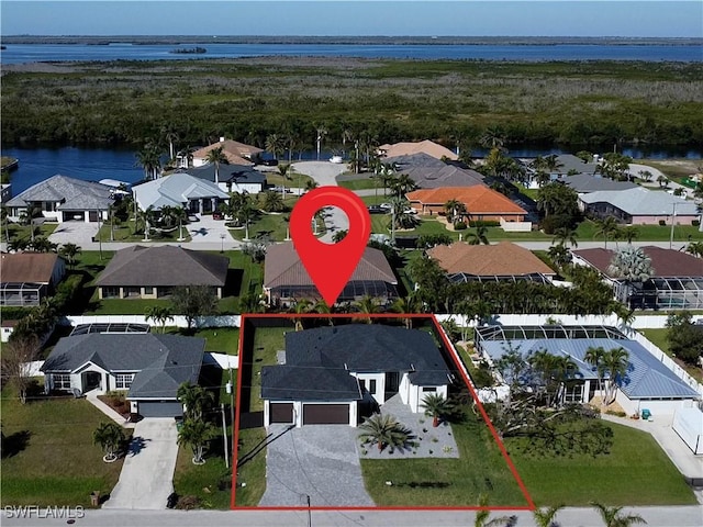 bird's eye view featuring a water view and a residential view