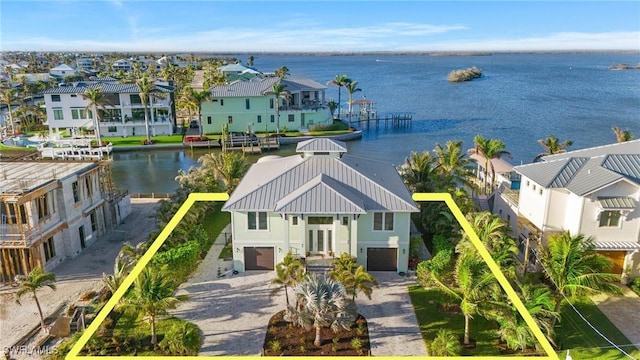 drone / aerial view featuring a water view and a residential view