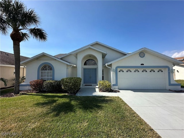 ranch-style home with a front yard, concrete driveway, an attached garage, and stucco siding