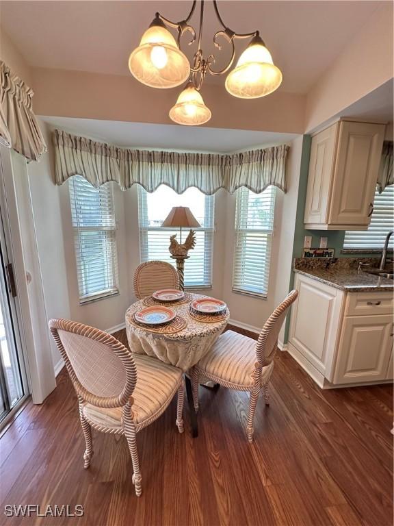 dining space with dark wood finished floors and baseboards