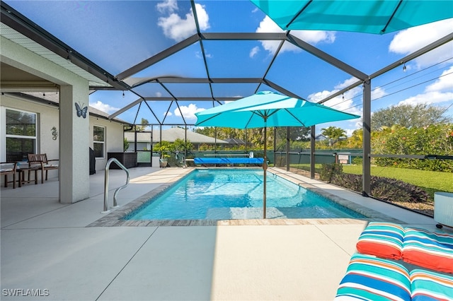 view of swimming pool featuring a patio and glass enclosure