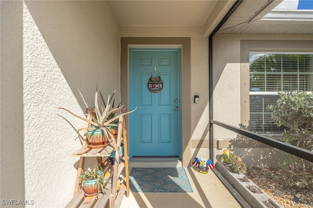 view of exterior entry featuring a balcony