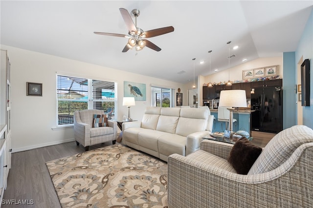 living room featuring lofted ceiling, dark hardwood / wood-style floors, and ceiling fan